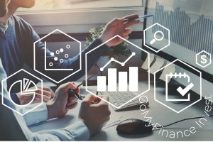 Financial analysts using the GoMyFinance Invest platform to review data charts, market trends, and investment portfolios on a desktop monitor with digital growth icons.