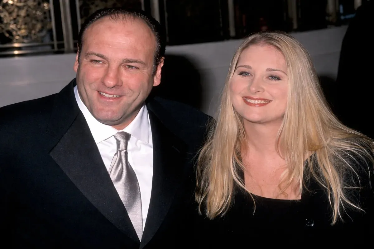 Marcy Wudarski smiling alongside a man in a black suit and silver tie at a formal event.