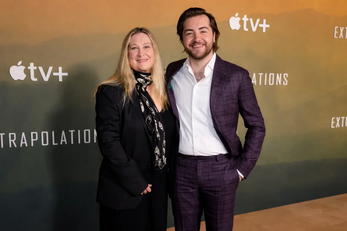 Marcy Wudarski posing with her son Michael Gandolfini on the red carpet at the Apple TV+ Extrapolation premiere event.