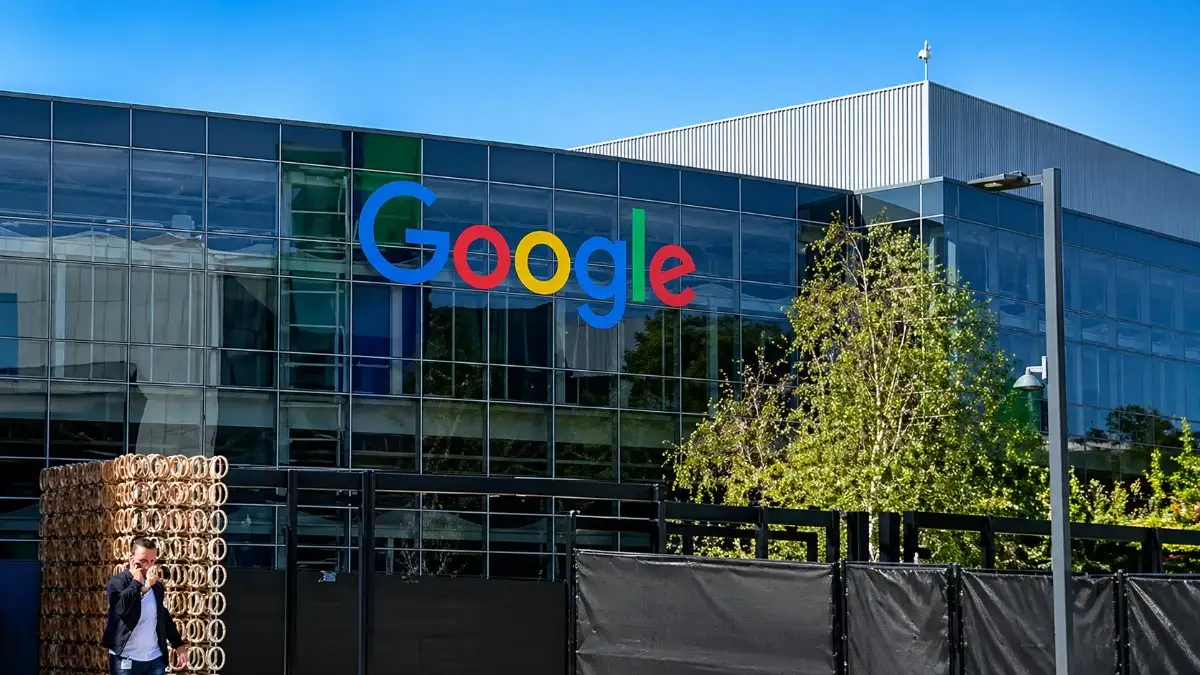 Google stock image of Alphabet Inc. modern glass headquarters building with Google logo on exterior, captured in HD 16:9 frame during daytime.