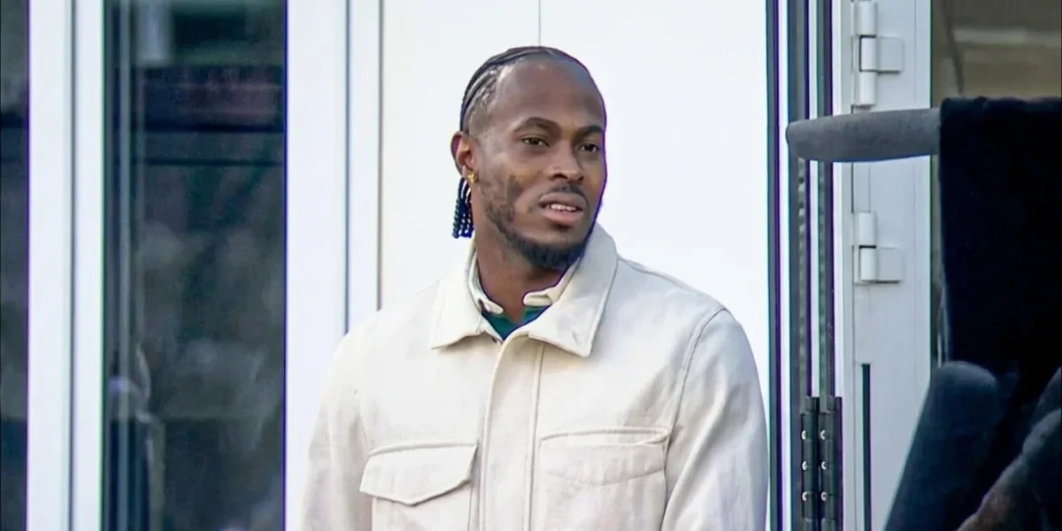 Jofra Archer net worth wearing a cream suede jacket with braided hair and blue beaded earrings, speaking candidly during a Sky Sports television interview appearance, with the Sky Sports watermark visible in the lower portion of the image.