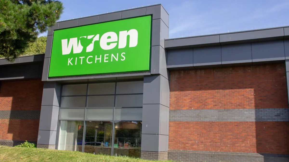 Wren Kitchens Chapter 7 storefront with green sign on modern brick building exterior