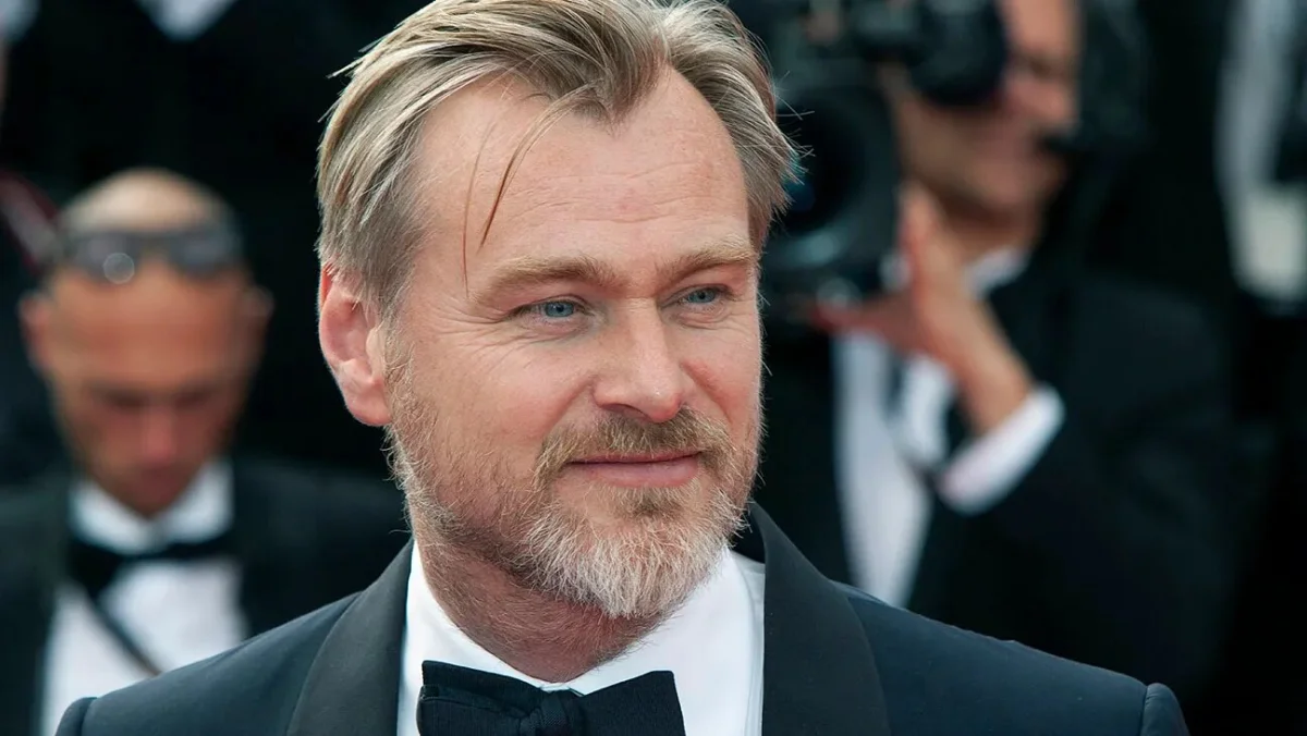 A professional portrait of filmmaker Christopher Nolan on a red carpet, often featured in discussions regarding the Christopher Nolan net worth and his success in the global film industry.