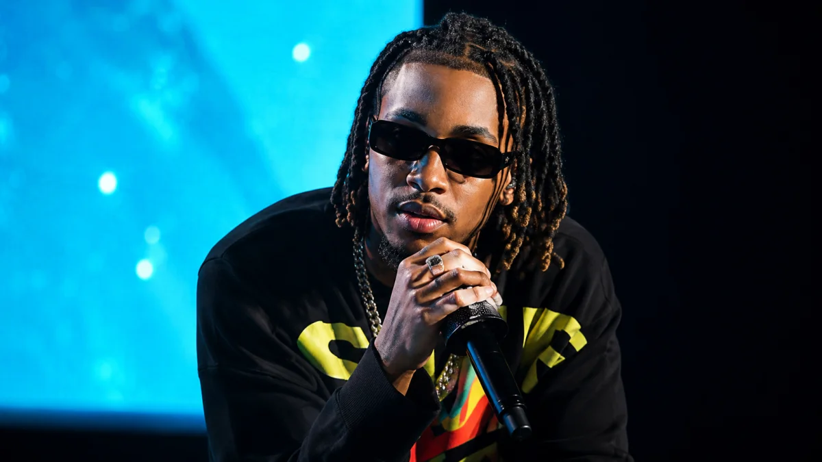 Celebrity-inspired performance portrait with sunglasses and microphone styling for DDG Net Worth related entertainment and music content.