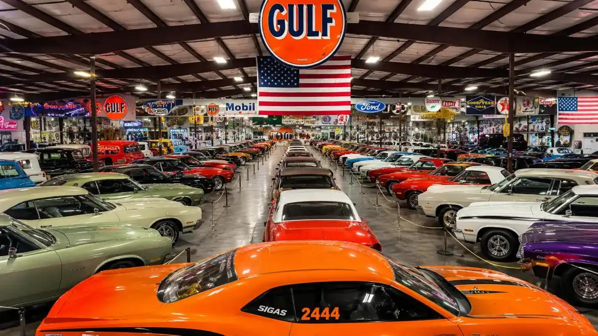 Large indoor classic car collection museum featuring vintage muscle cars and luxury automobiles – Don Baskin Net Worth