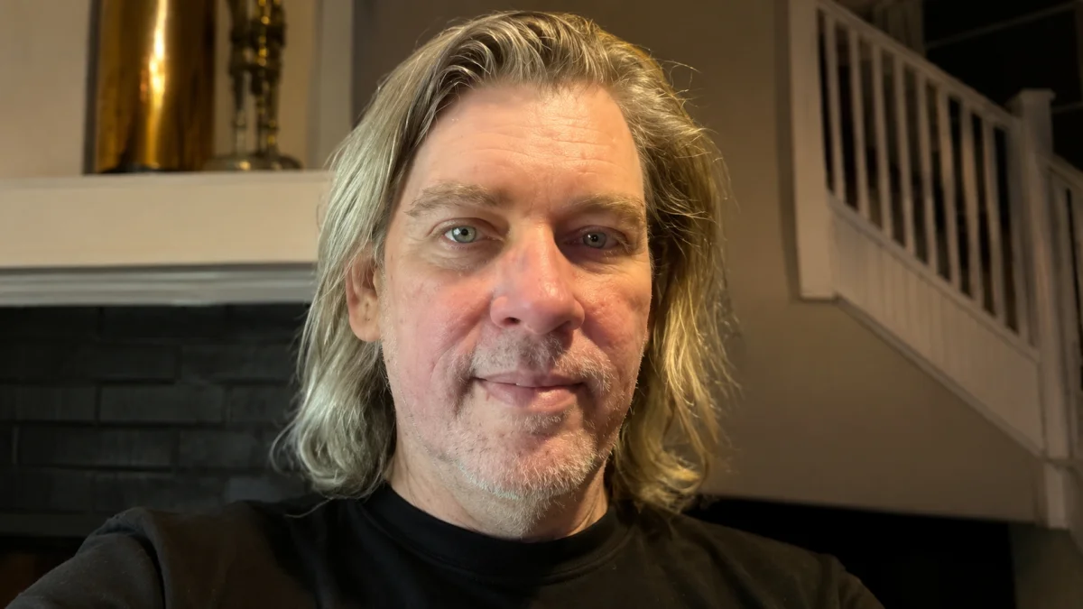 Kevin Knasel Net Worth portrait image with long hair and casual indoor background looking at camera