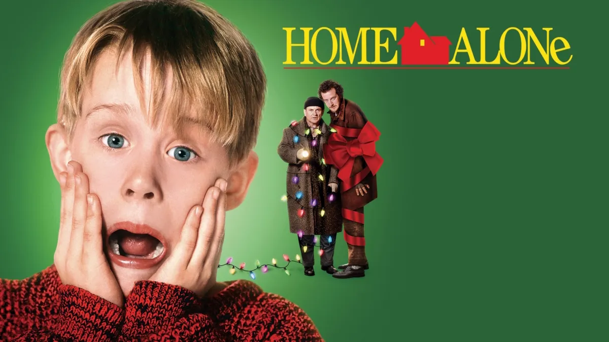 The iconic Home Alone movie poster featuring a young Macaulay Culkin with hands on cheeks and mouth open in his signature shocked expression, alongside the two bumbling burglars wrapped in Christmas lights — the blockbuster film role that launched Macaulay Culkin net worth and cemented his status as Hollywood's most beloved child star.