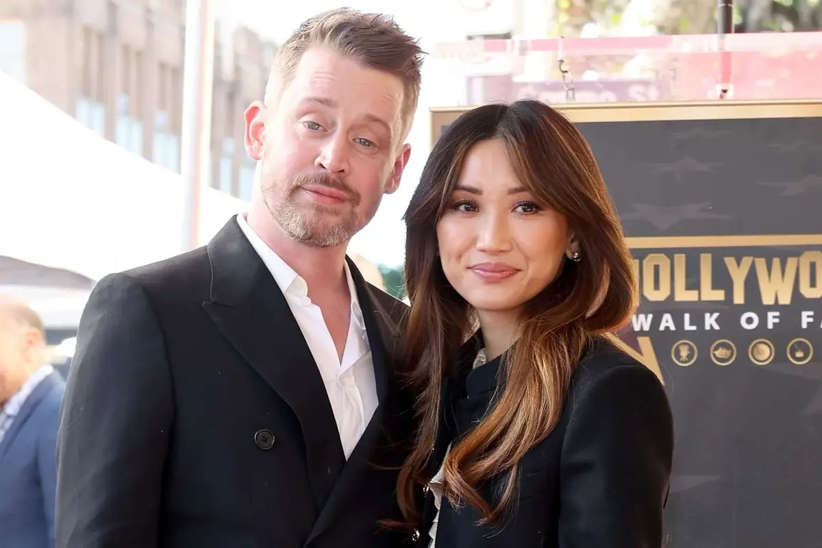 Actor Macaulay Culkin and fiancée Brenda Song at his 2023 Hollywood Walk of Fame ceremony, reflecting the enduring legacy and growing Macaulay Culkin net worth estimated at $25 million to $30 million in 2026.