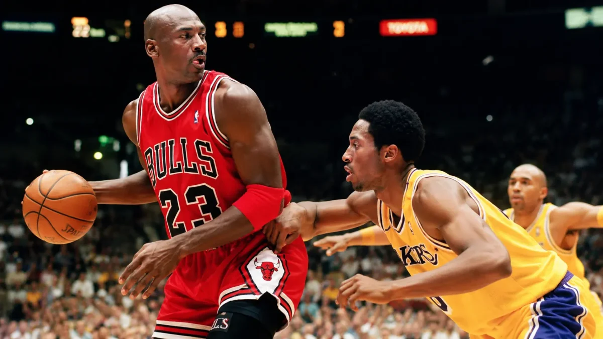 Michael Jordan dribbling the basketball during Chicago Bulls vs Lakers game – Michael Jordan Net Worth and NBA legend action photo