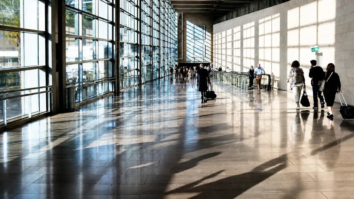 Spirit Airlines themed airport terminal interior with travelers walking through a modern travel industry hub