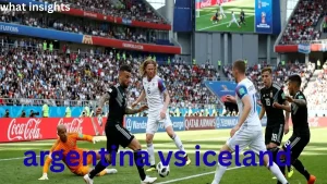 Football players in black and white kits fighting for possession of the ball on a green pitch in a crowded stadium during the historic Argentina vs Iceland world cup match.
