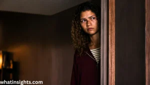 Rue Bennett peers from a doorway in a tense and emotional scene from the Euphoria finale, highlighting a pivotal moment in the series ending.