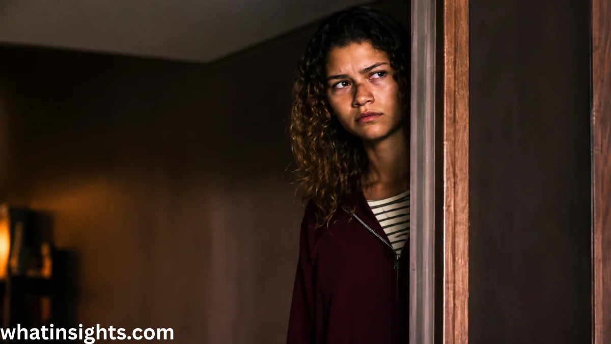 Rue Bennett peers from a doorway in a tense and emotional scene from the Euphoria finale, highlighting a pivotal moment in the series ending.